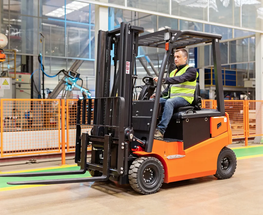 Storehouse employee in uniform working on forklift